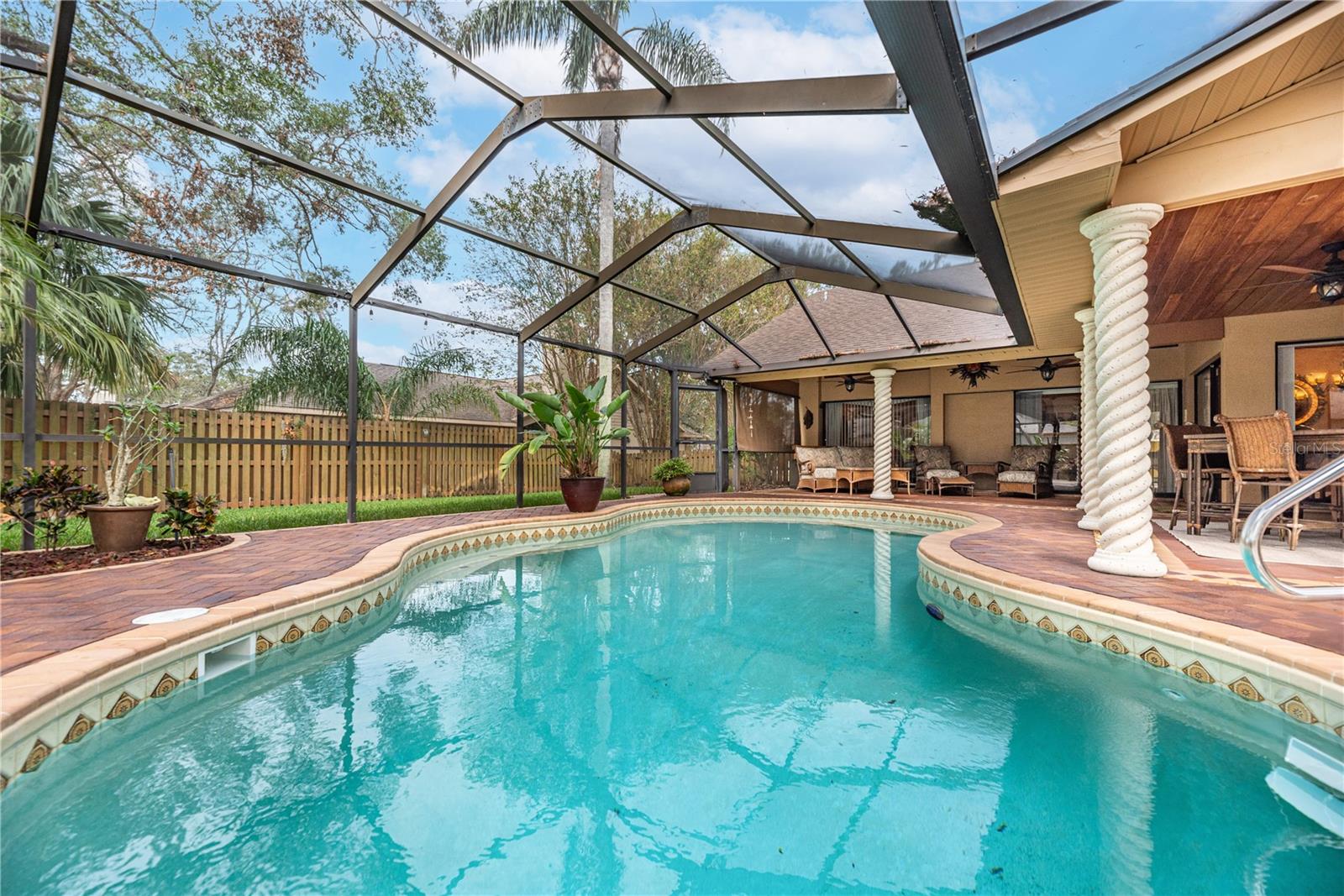 The details and craftsmanship continue outside as well.  Stylish pavers with inlaid designs, spiral columns and pool tile accents are icing on the cake.