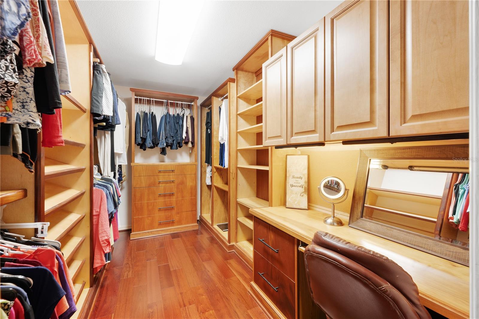 This huge walk-in closet with built-in shelving and make-up table will make you drool.