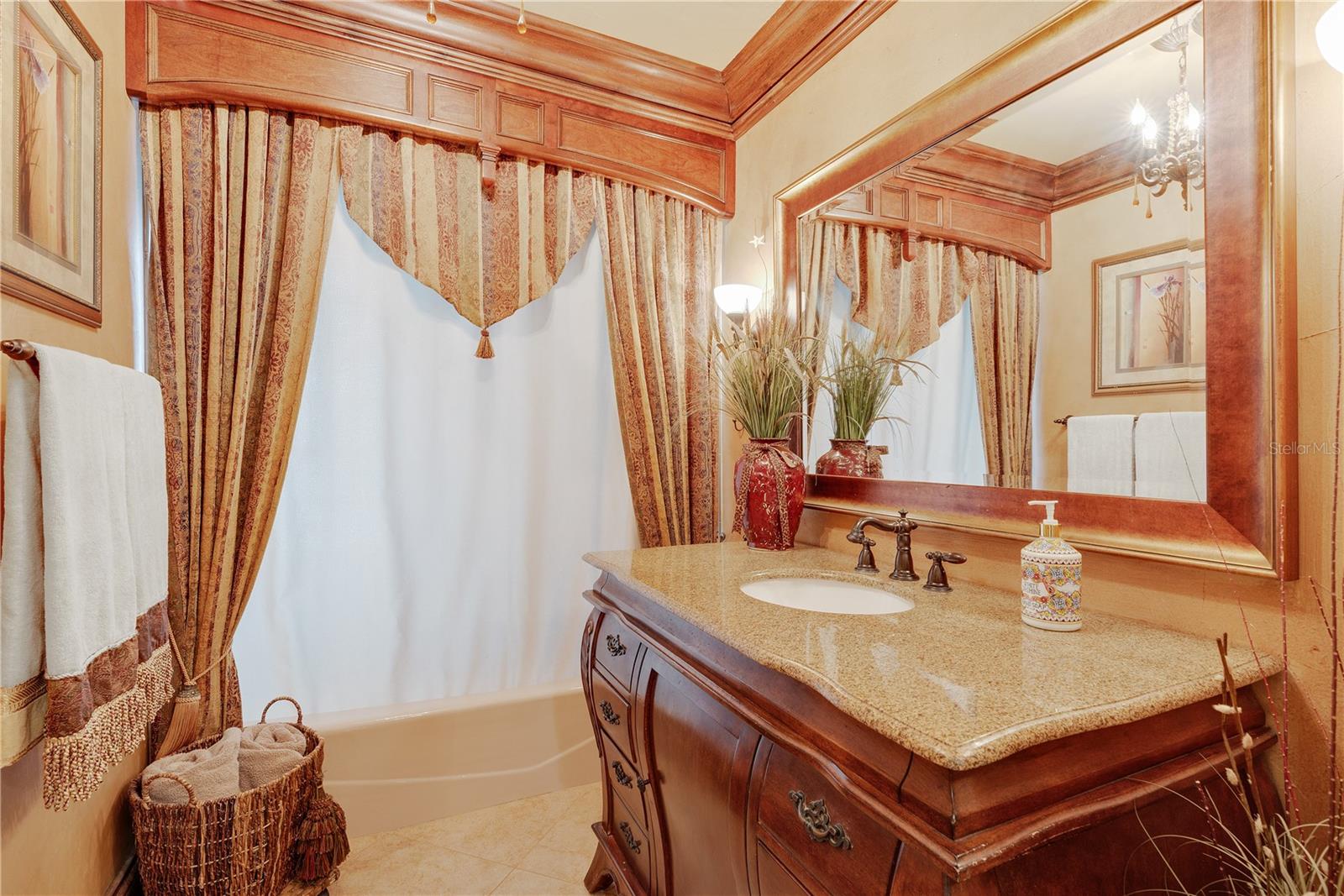 The secondary bathroom has been upgraded with a vintage dresser sink vanity, and has a tub/shower combo.