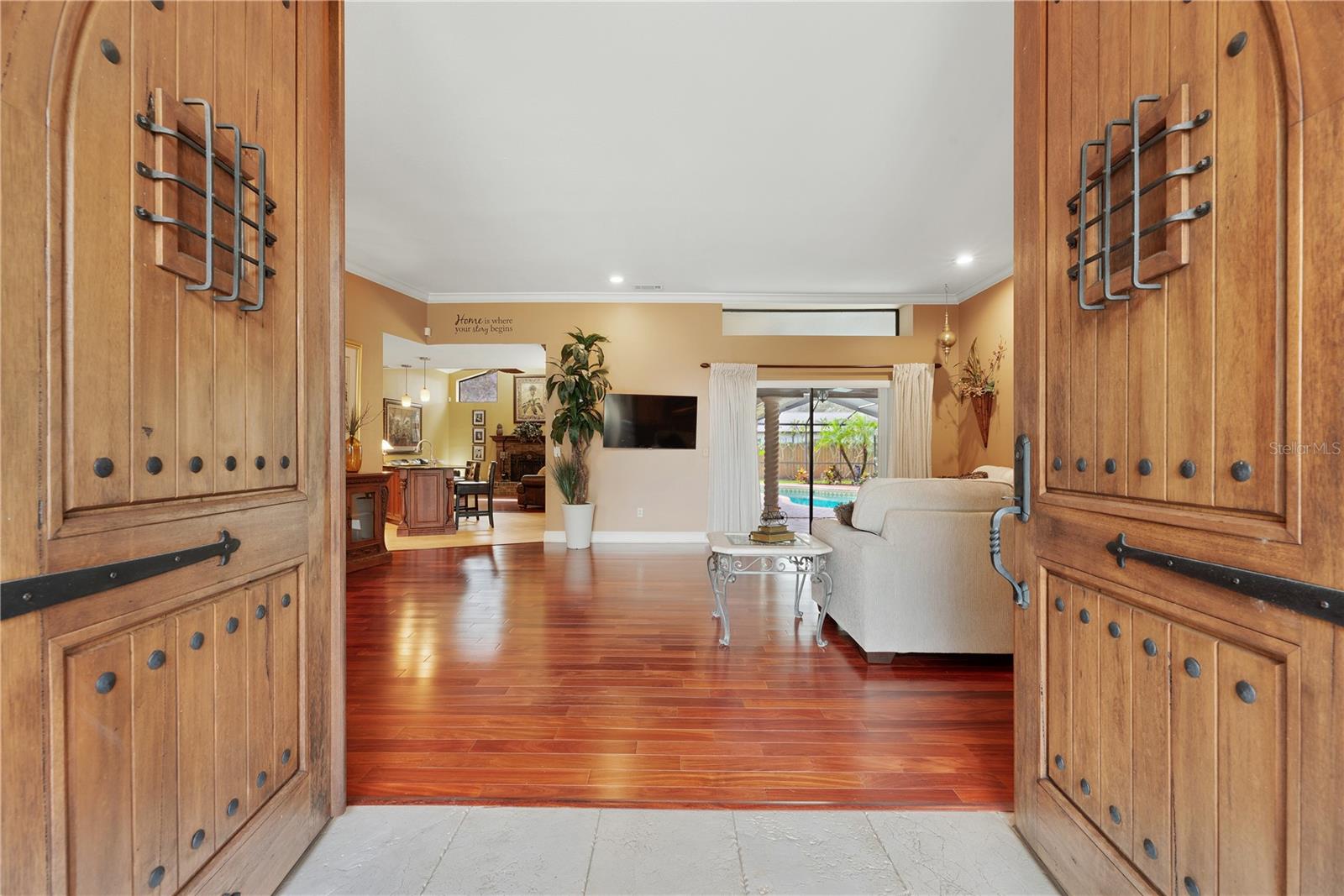 Arched solid Alder double entry doors with working speakeasy doors to greet your visitors.