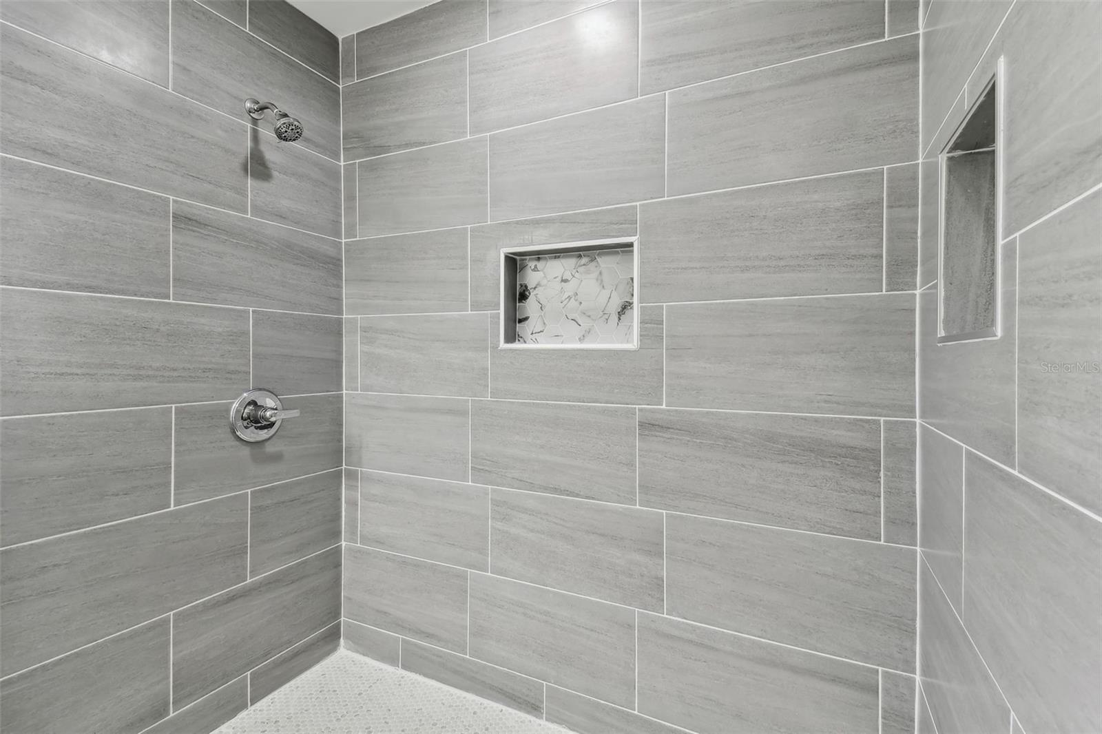 Walk in tiled shower in owners bath.