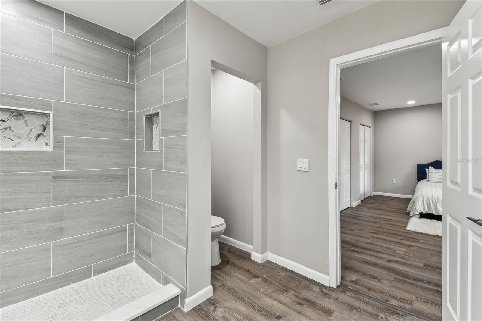 Walk in tiled shower in owners bath.