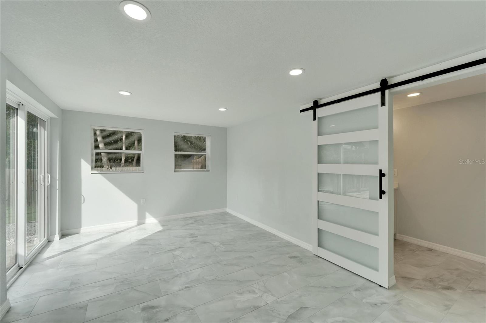 Master en-suite with barn door entry to master bath & laundry room.