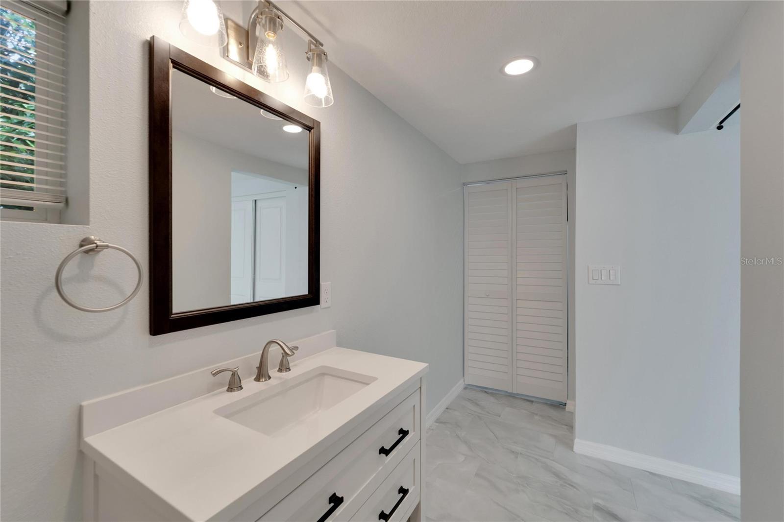 Master bath with view to laundry room.