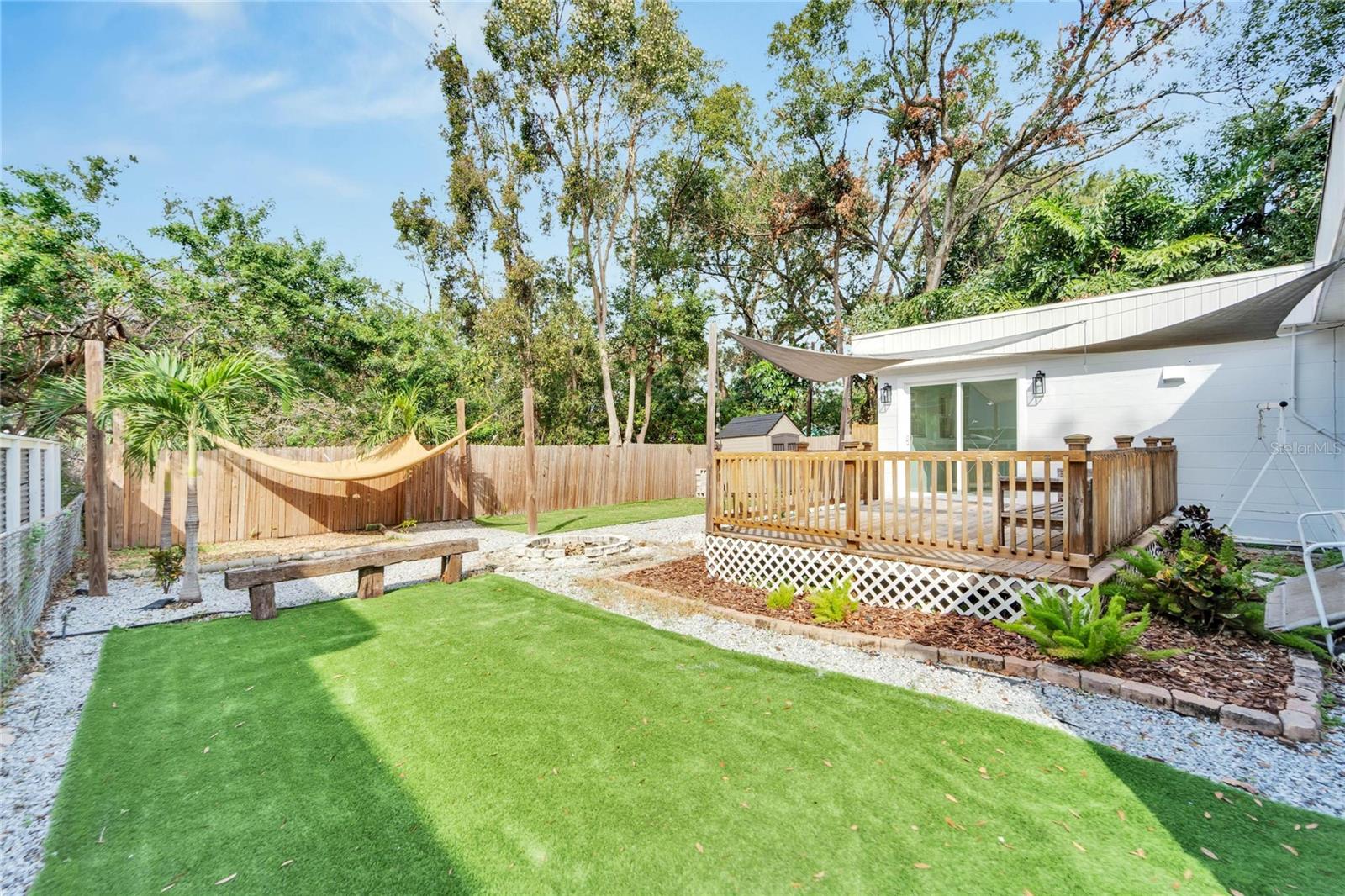 Backyard oasis with an outdoor shower and many areas to relax & unwind.