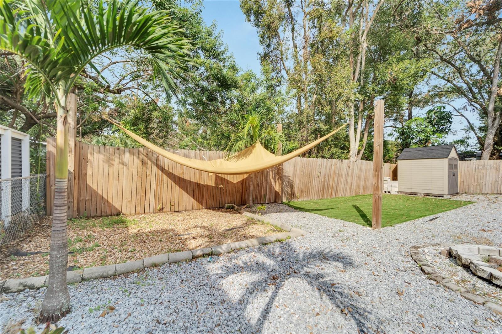 Backyard oasis with an outdoor shower and many areas to relax & unwind.