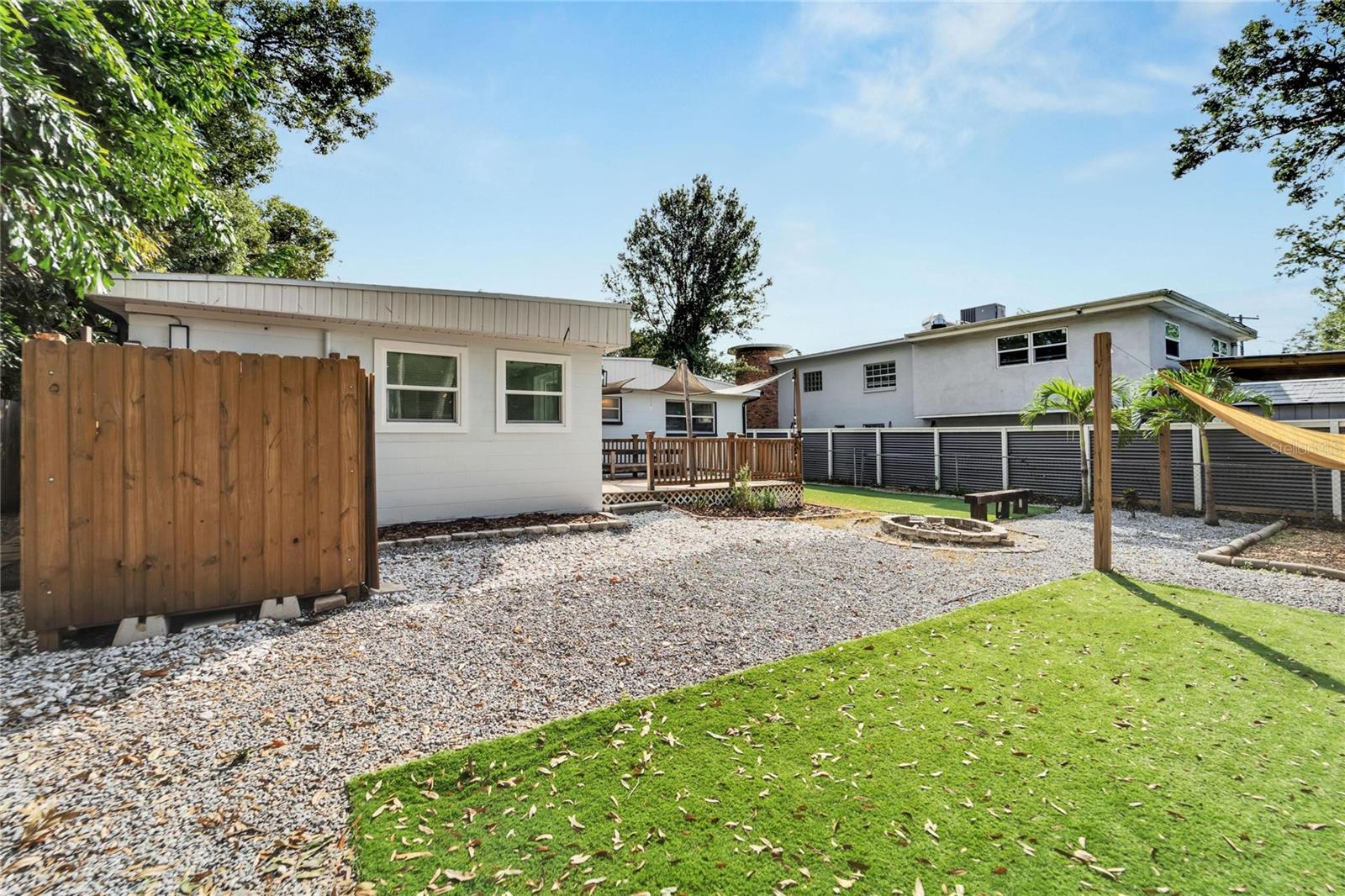 Backyard oasis with an outdoor shower and many areas to relax & unwind.