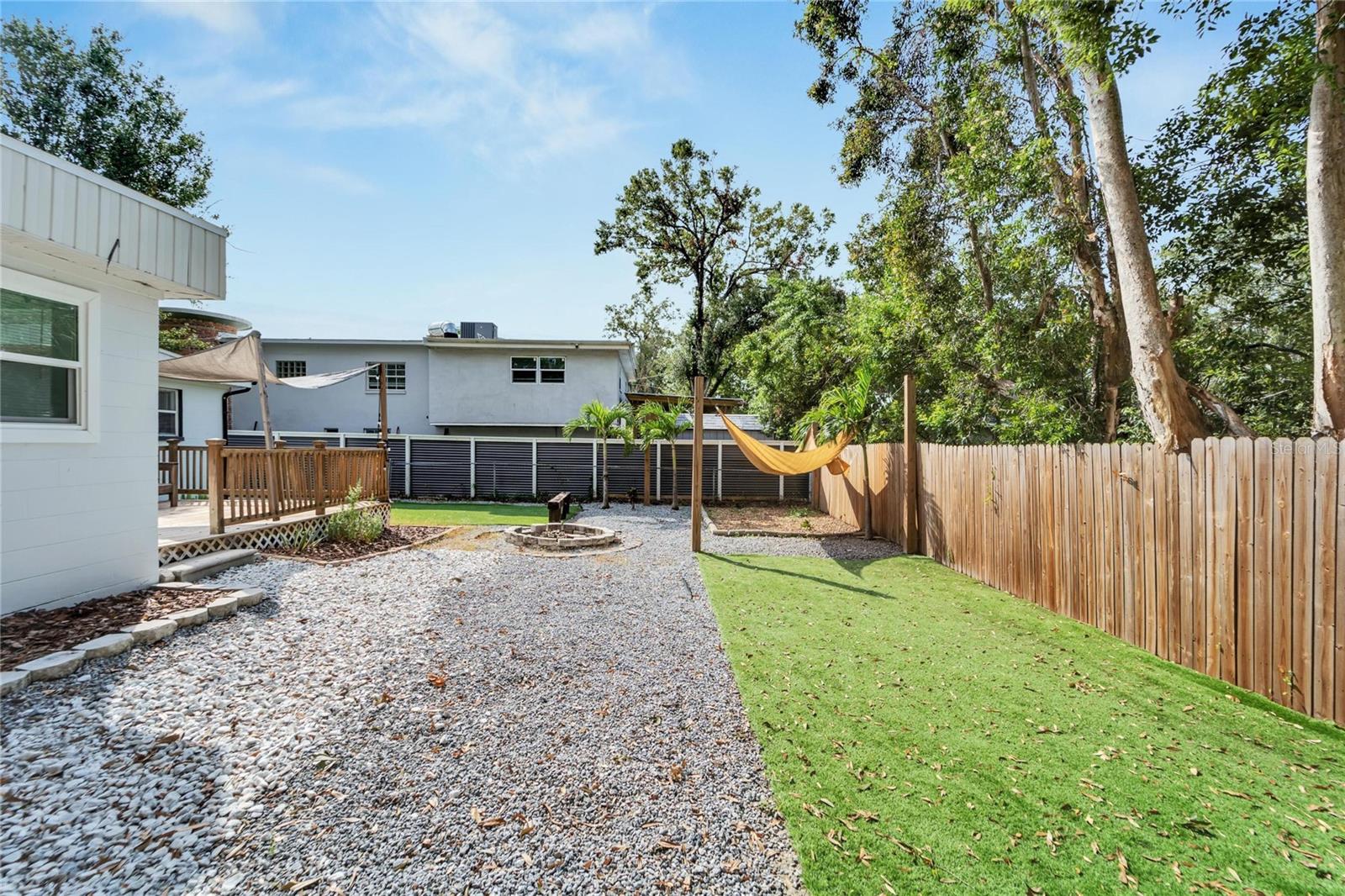 Backyard oasis with an outdoor shower and many areas to relax & unwind.