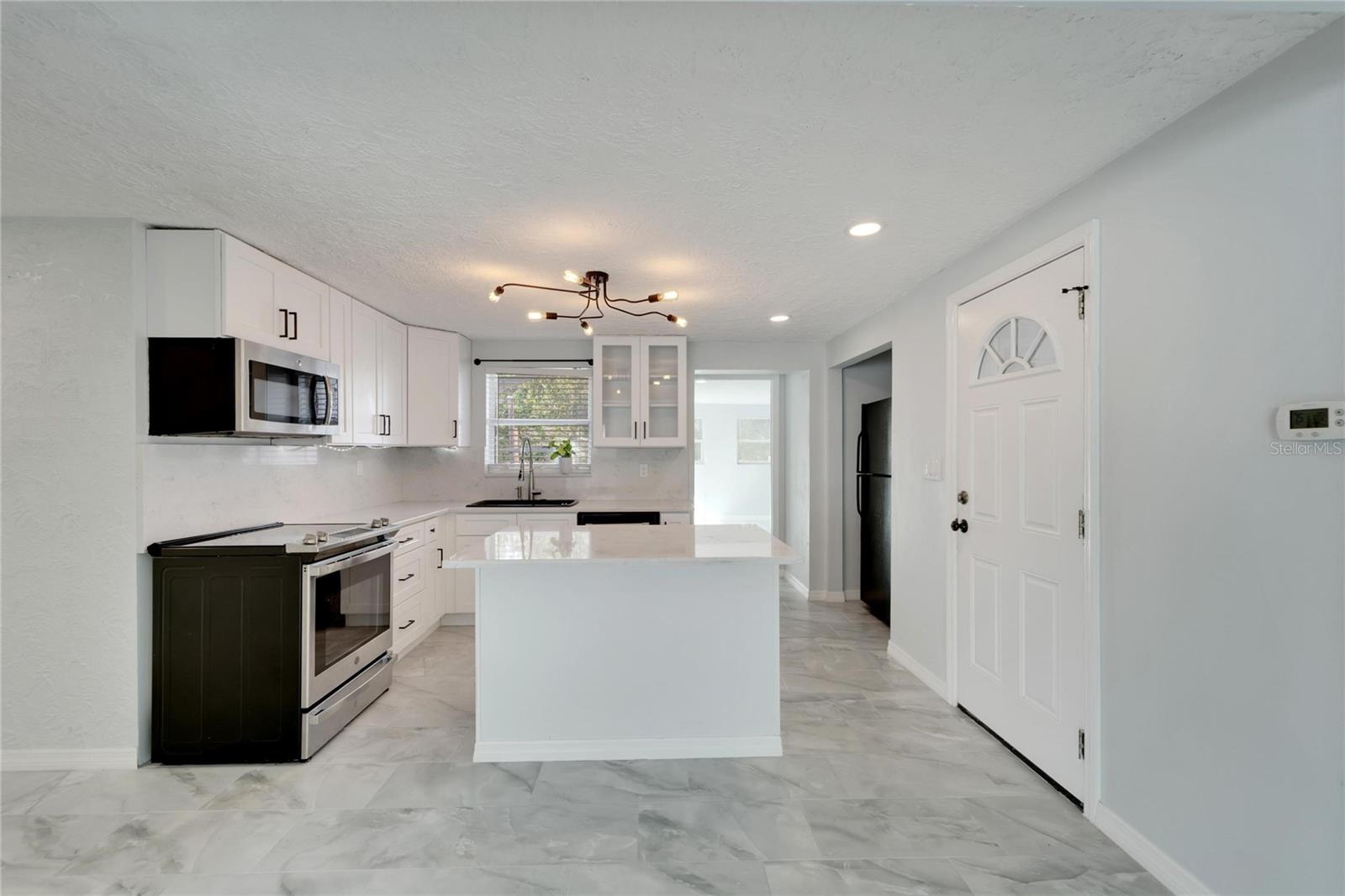 Kitchen with stainless steel appliances and ceramic countertops.