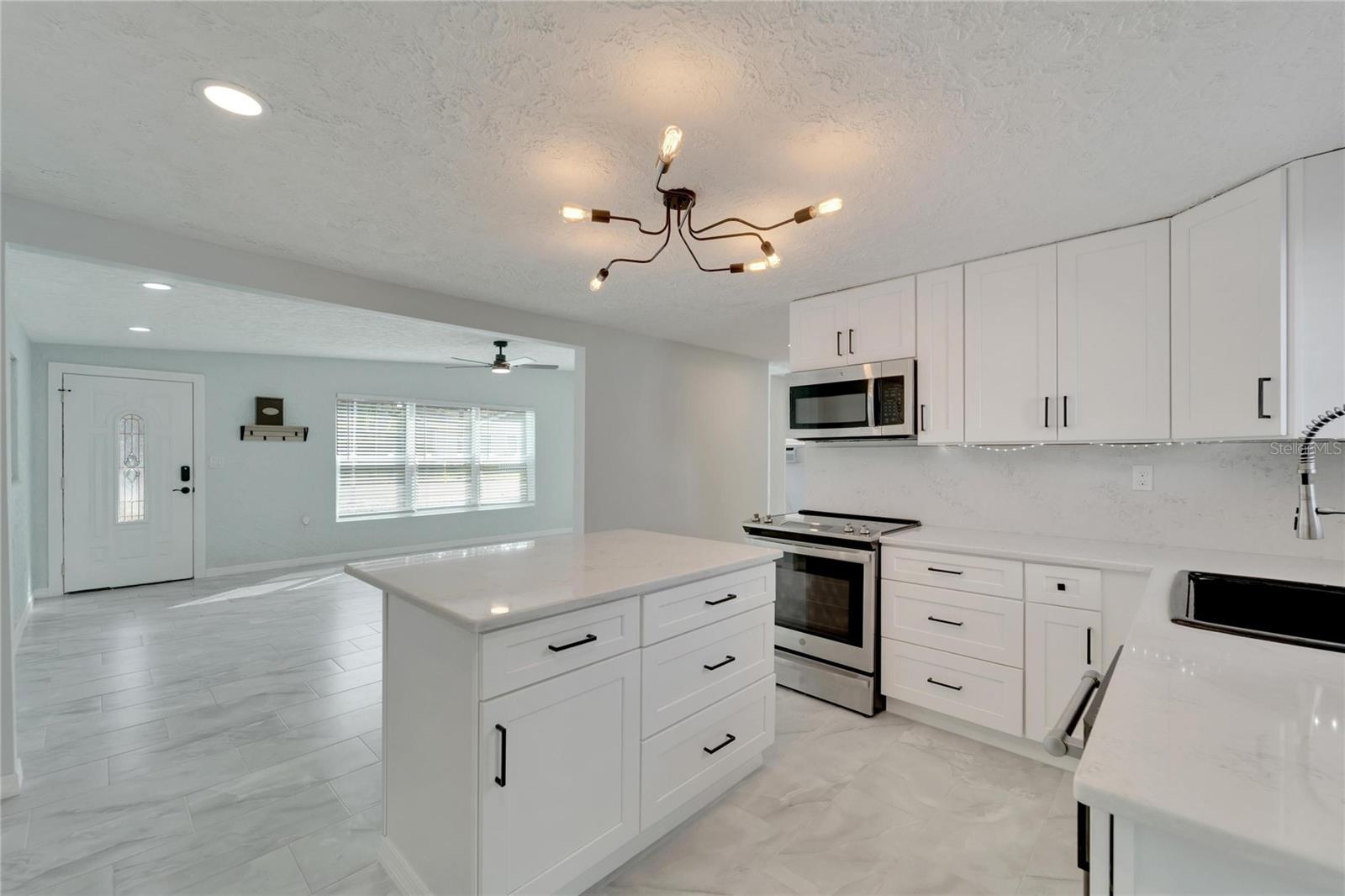 Kitchen with stainless steel appliances and ceramic countertops.