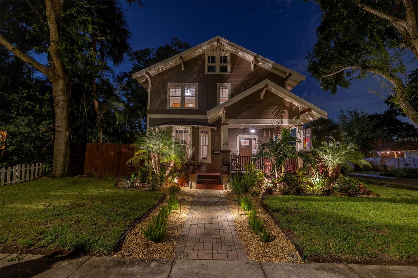 Stunning evening uplighting on the front of home and landscaping!