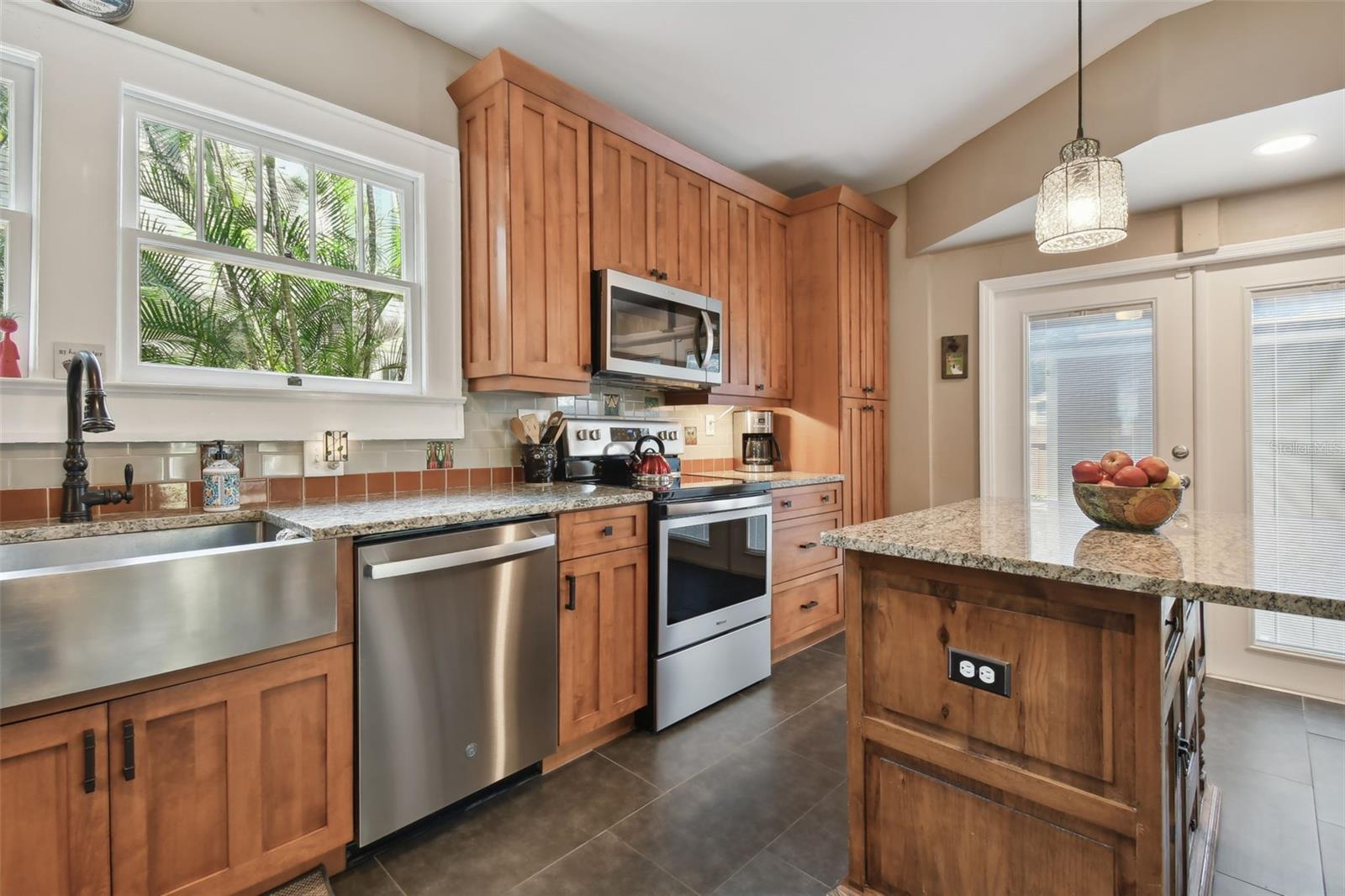 Solid wood maple cabinets and added electrical outlet to center island for food prep or laptop needs.