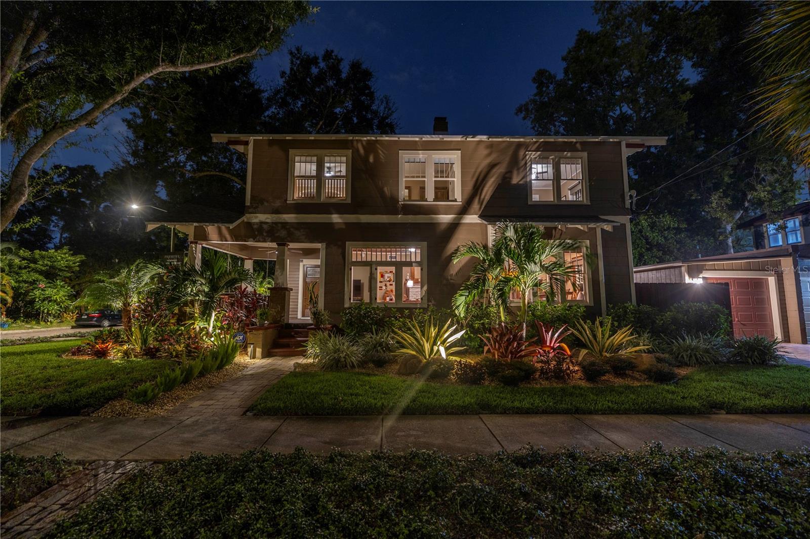 Outdoor lighting highlights the home and gorgeous landscaping.