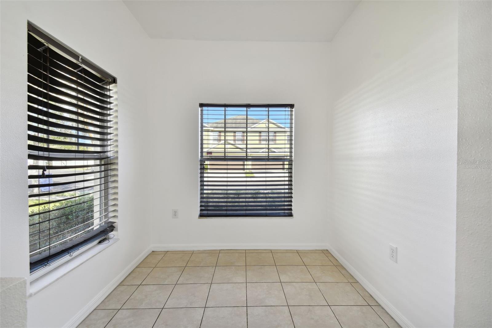 kitchen dinette with multiple windows for ample lighting (virtually staged)