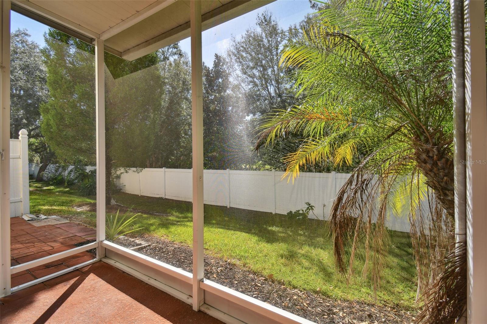 fully screened in private back patio with treeline views