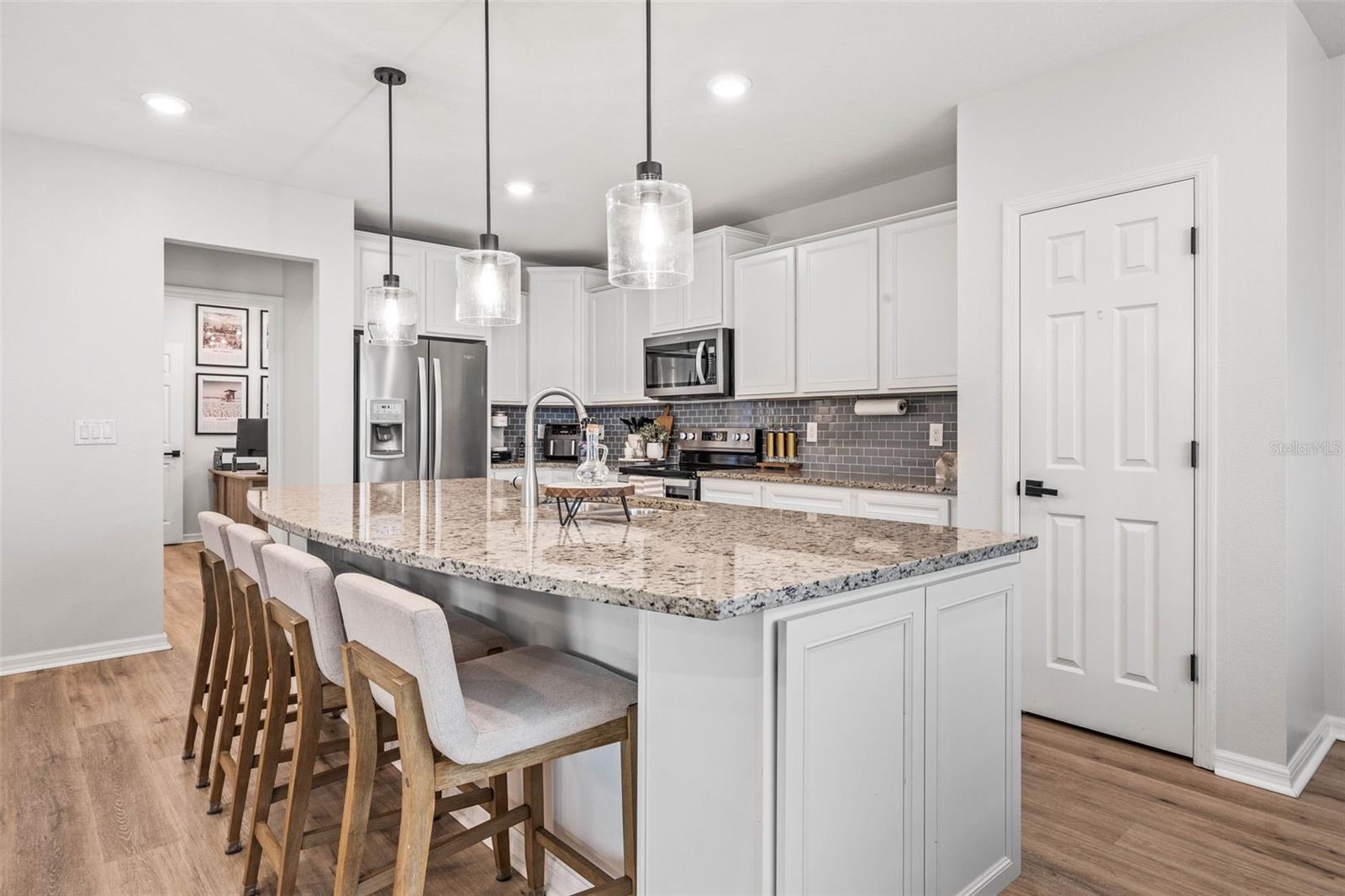 Your kitchen features an island to seat 4, crowned cabinetry, and stainless steel appliances.