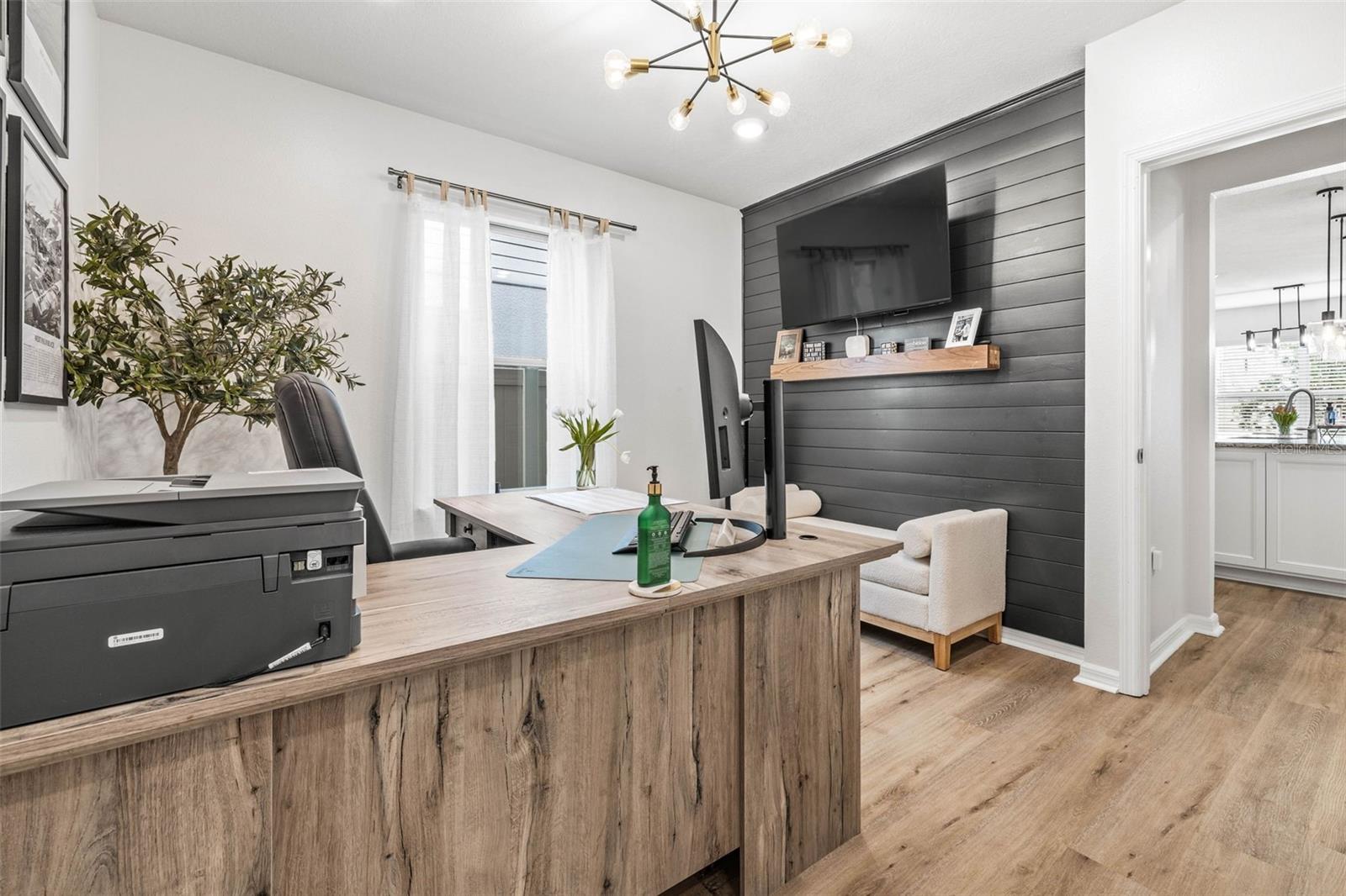 Accent wall with shiplap & overhead lighting fixture.