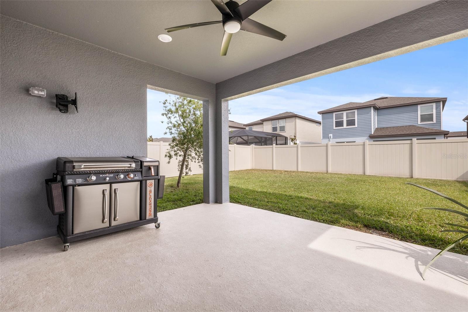 The outside lanai leads to the large fenced in yard.