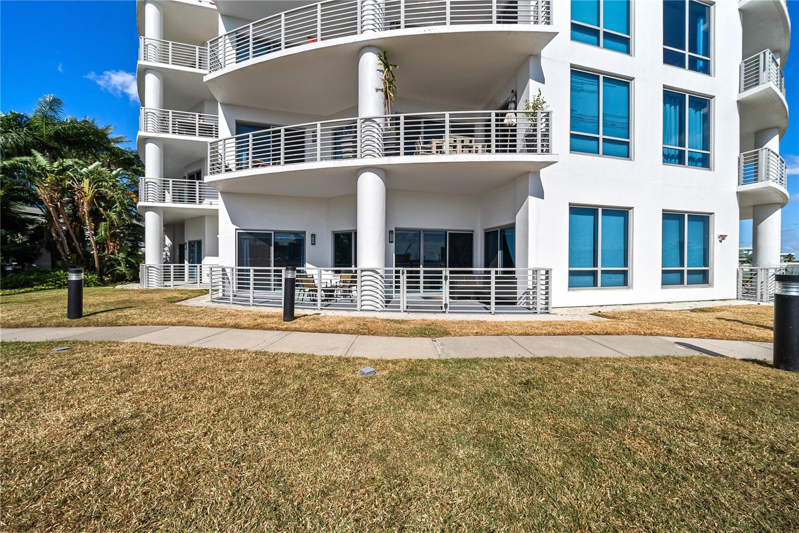 View of patio with walking paths directly to the pool and dog park.