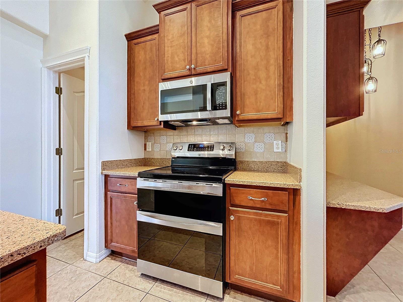 Kitchen featuring double oven and new microwave