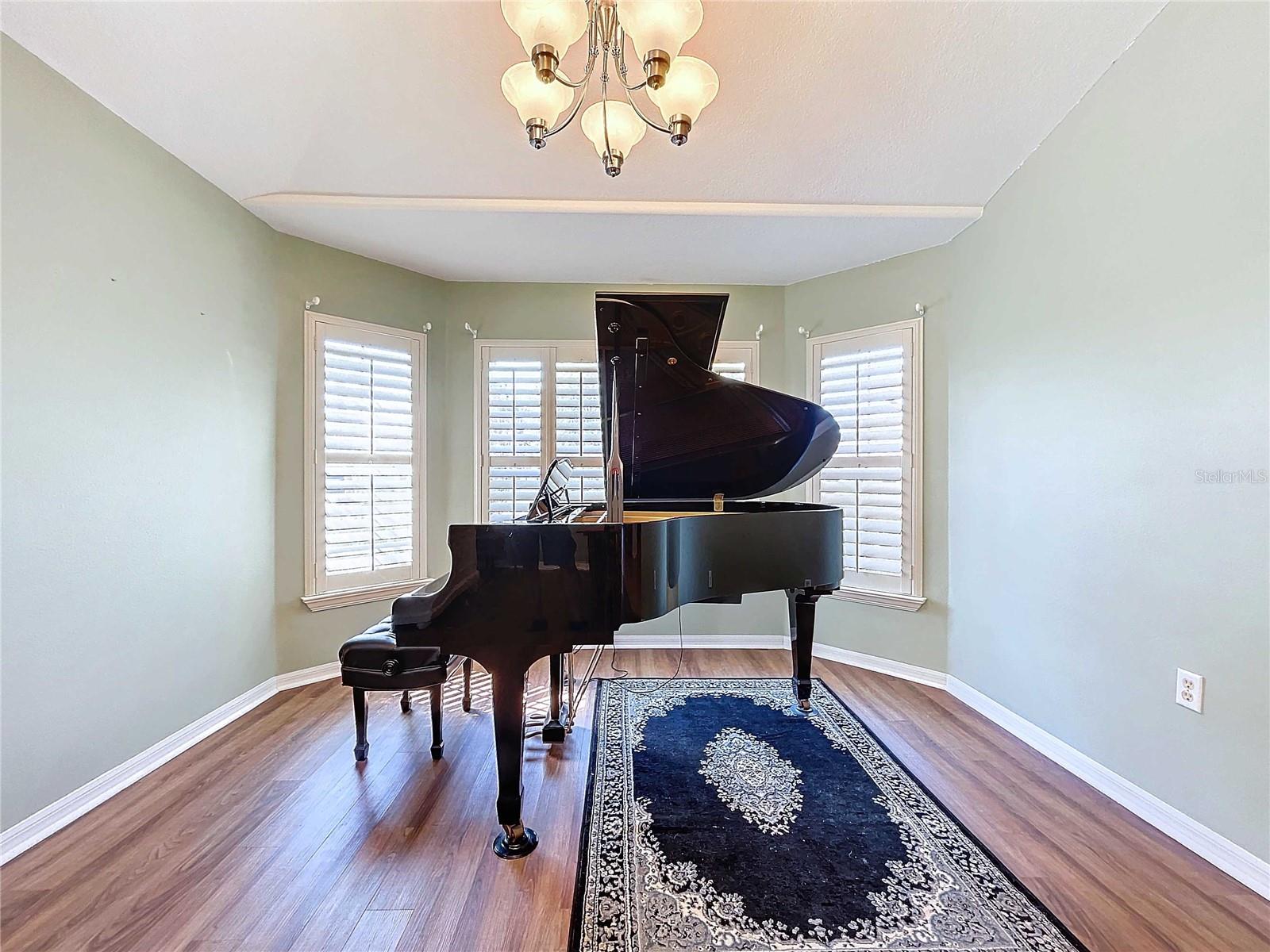 Living room featuring bay windows & plantation shutters