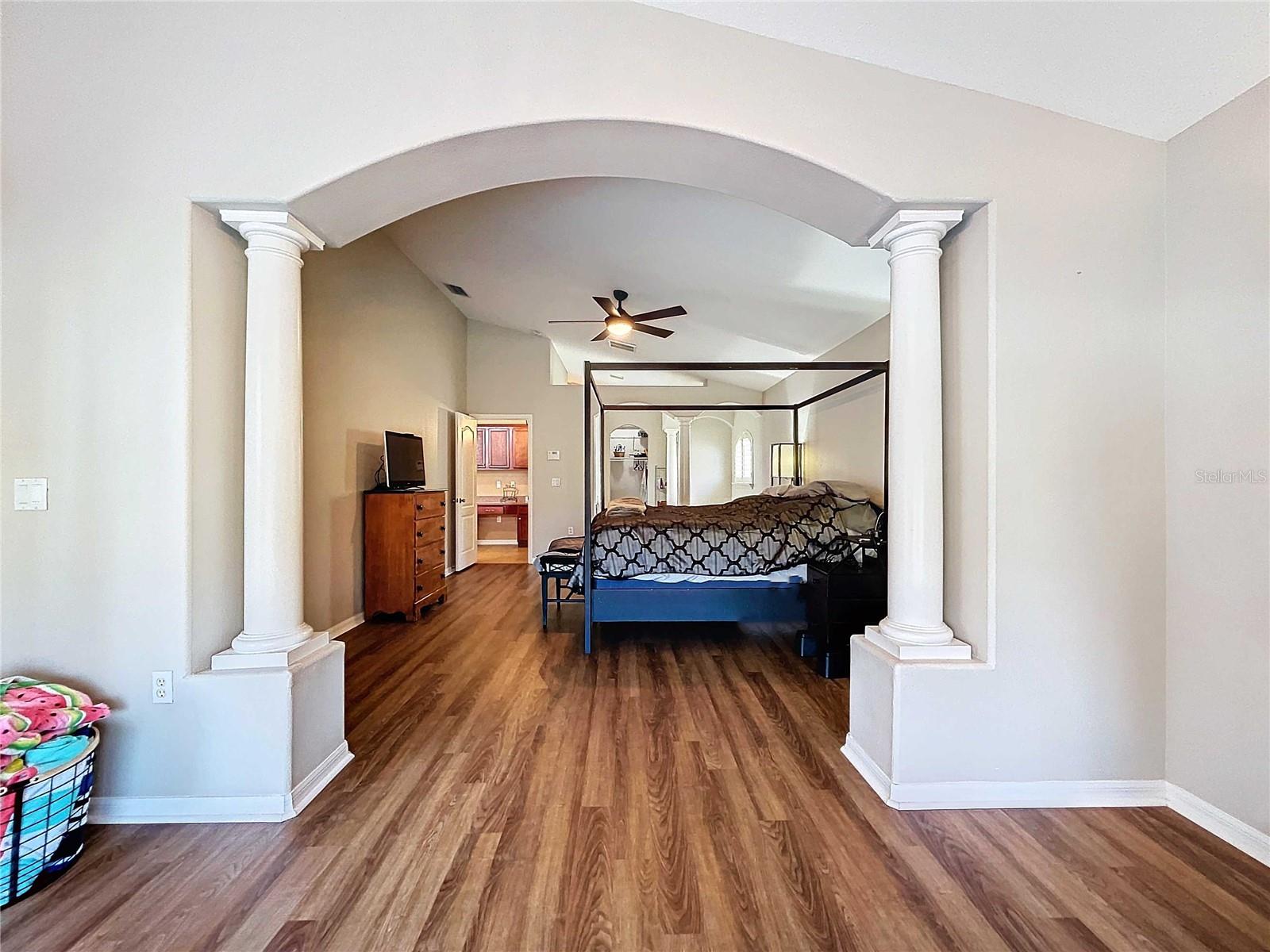 Primary bedroom & sitting room featuring vinyl flooring