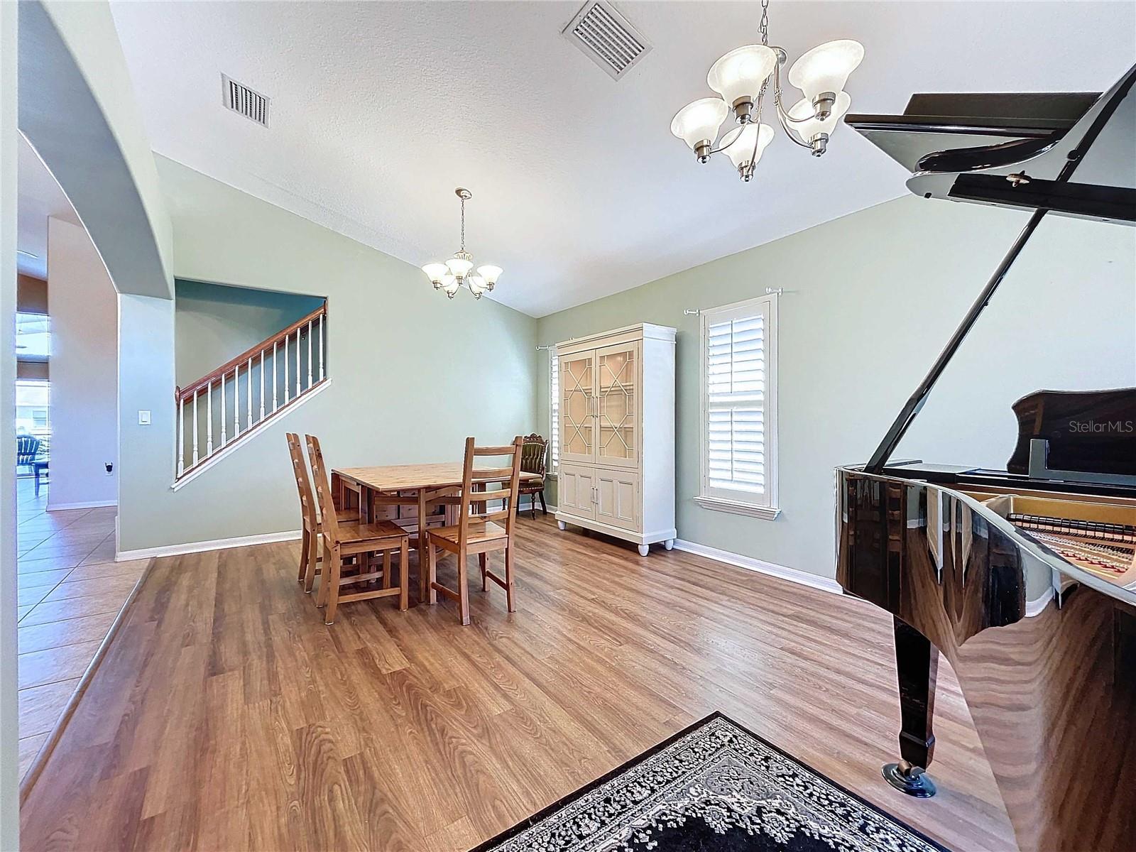 Living/Dining room combo featuring vinyl flooring