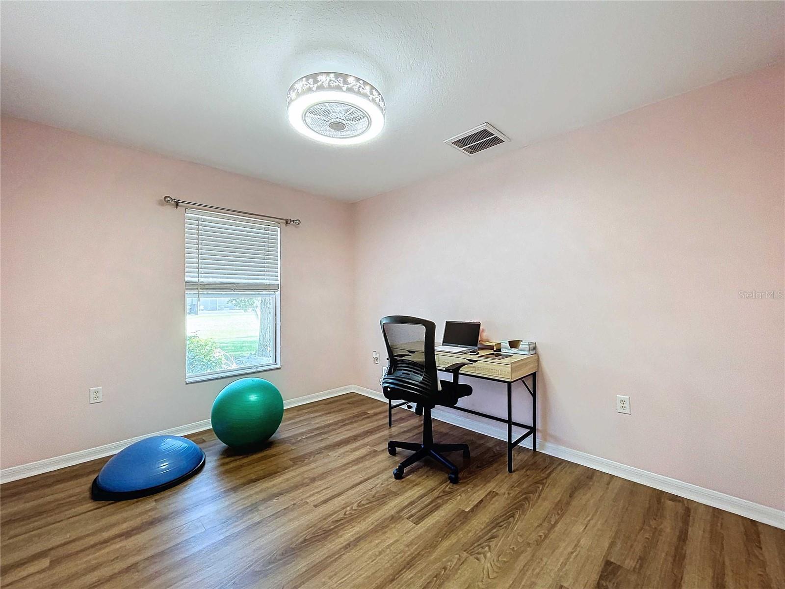 Third bedroom with vinyl flooring & custom fan. New paint