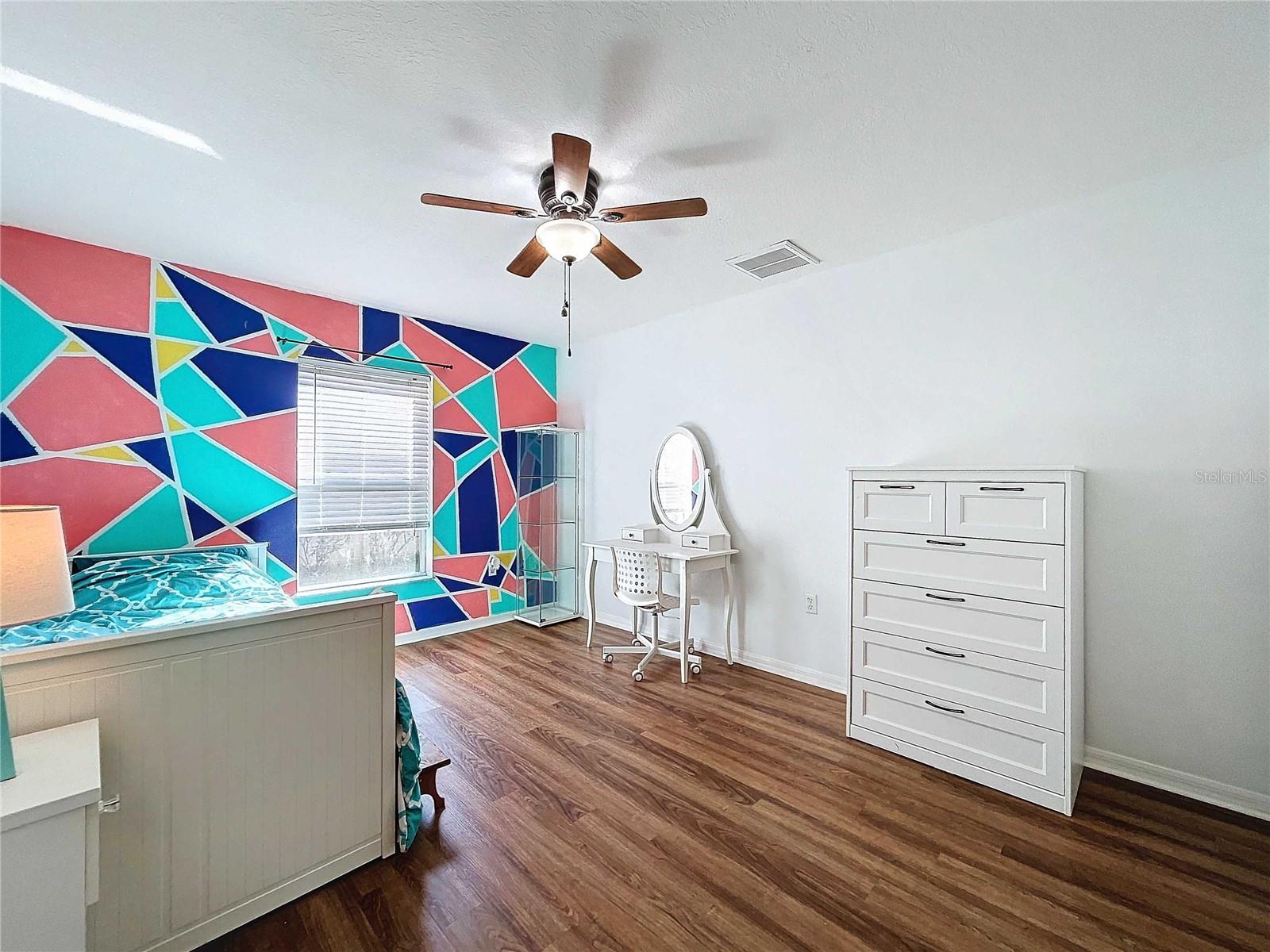 Downstairs second bedroom with vinyl flooring