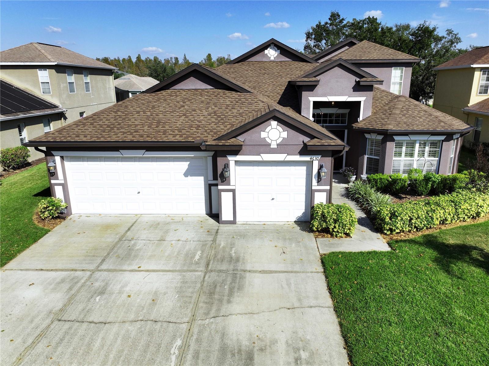 Aerial curbside view with large 3 car wide driveway