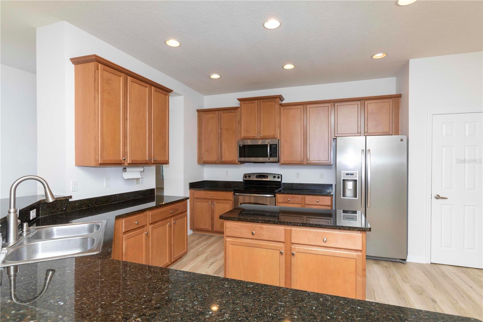 wood cabinets and granite countertops