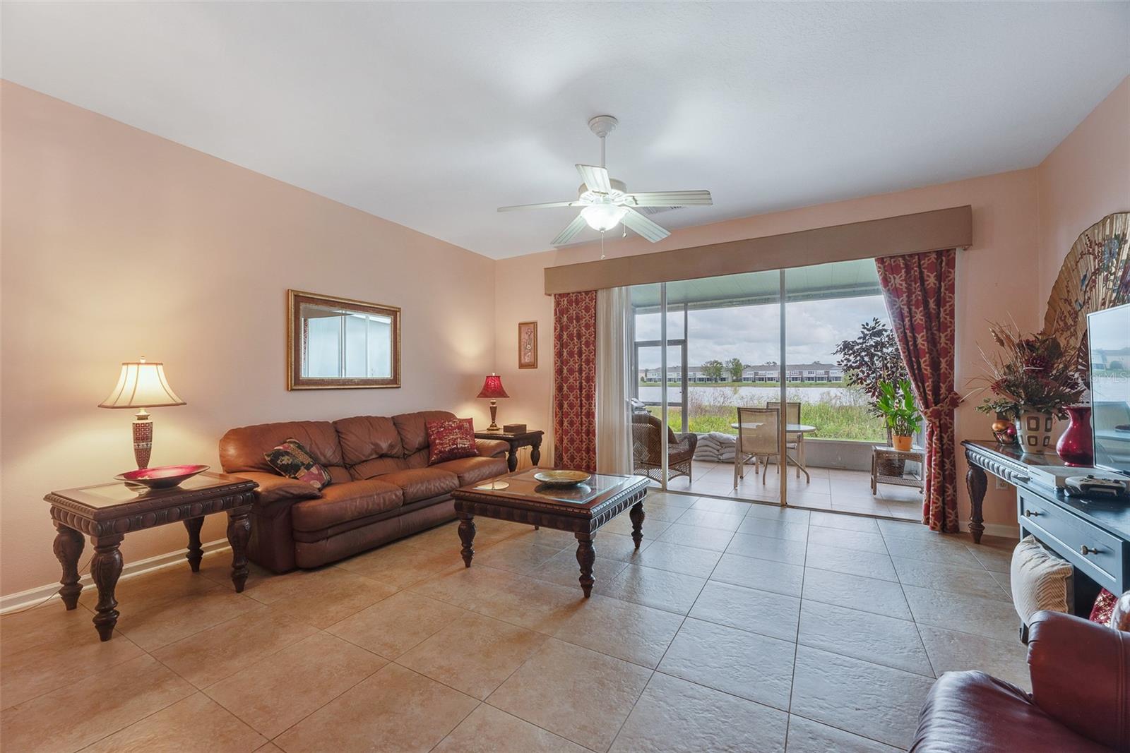 Large Living room with room for a Dining table is open to the kitchen and has a screened in back porch overlooking a water view.