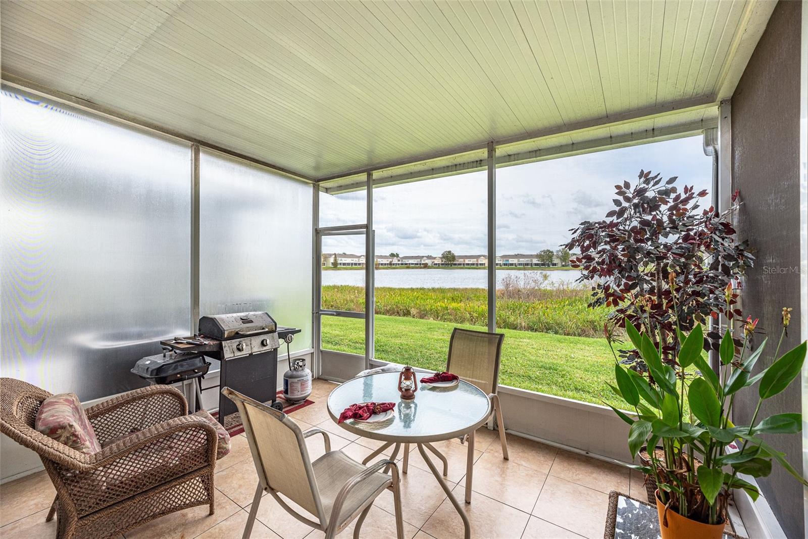 10x13 back patio with tranquil water views is screened and protected from the weather.  Perfect place to relax!