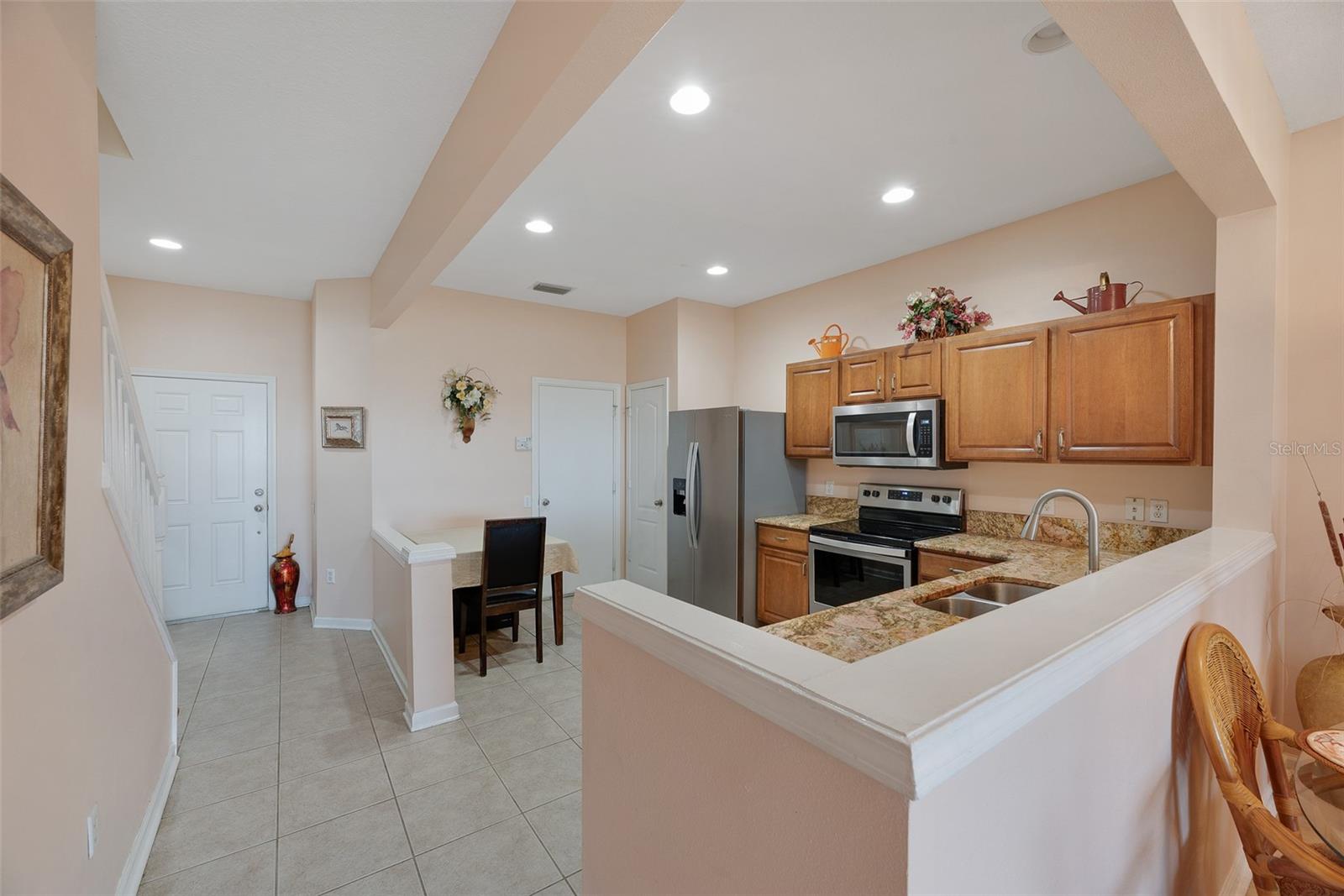 A half wall separates the kitchen from the dining area/living room for open sight lines.