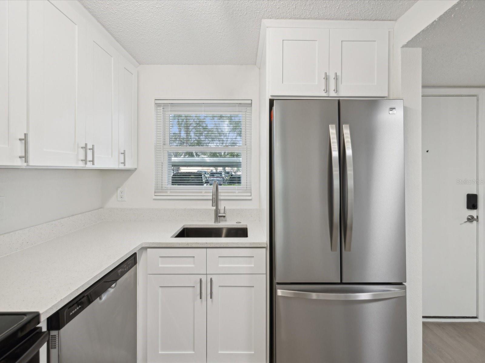 kitchen with new stainless appliances and quartz countertop