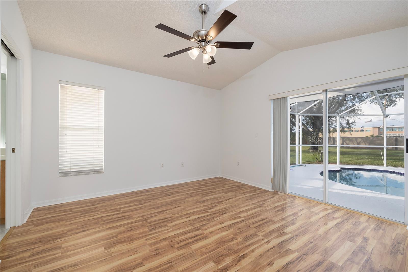 Primary bedroom with sliders to the pool