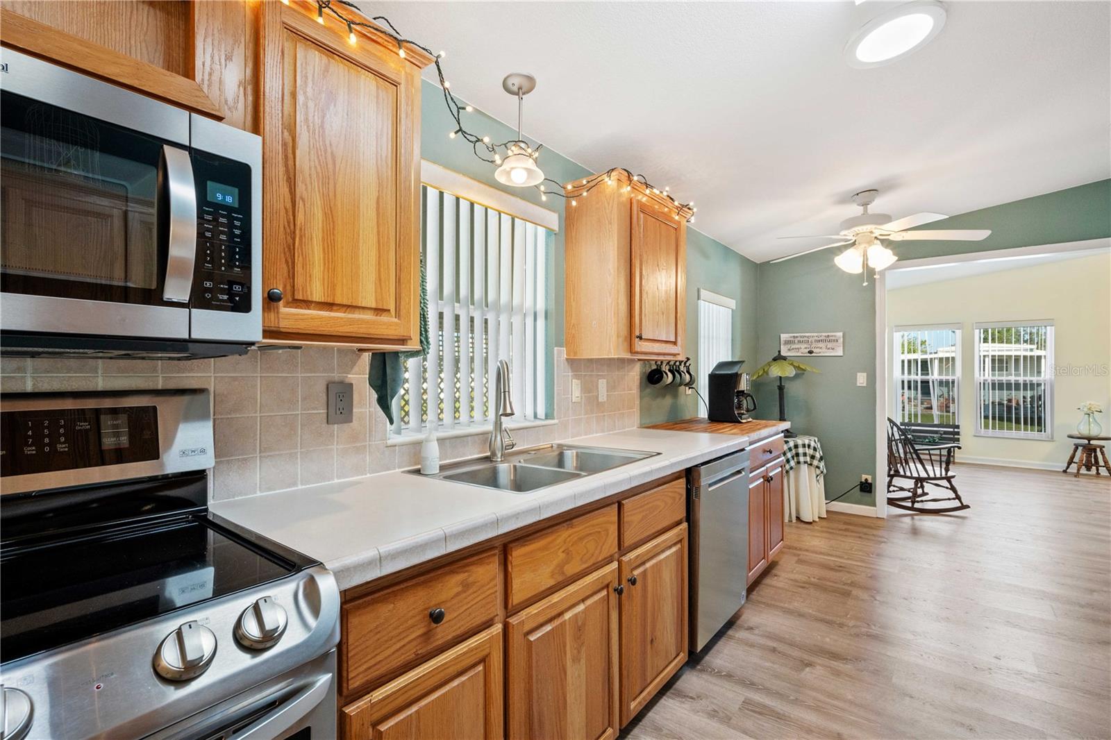 Don't miss this incredible kitchen with updated stainless-steel appliances, luxury vinyl flooring, ceiling fan, large walk=in pantry, and so much more.