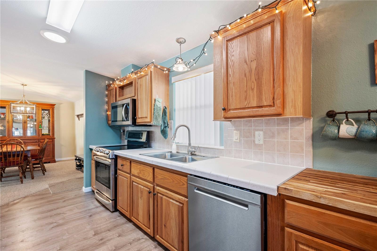 Tile backsplash in this kitchen with updated fixtures.