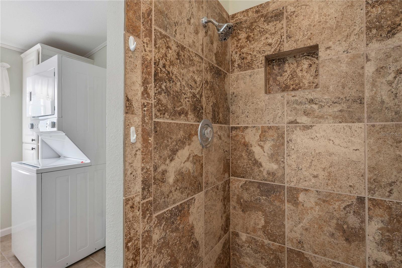 Custom tiled shower with built-in bench.