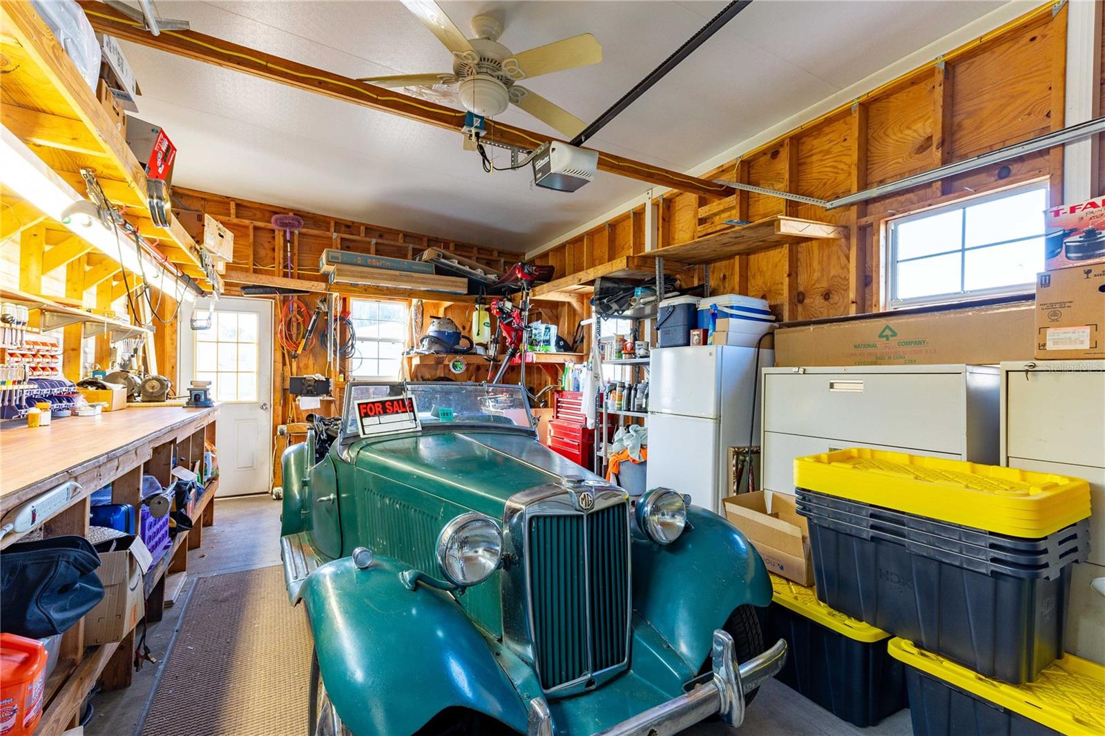 This garage offers workshop (work bench conveys) and extra storage.