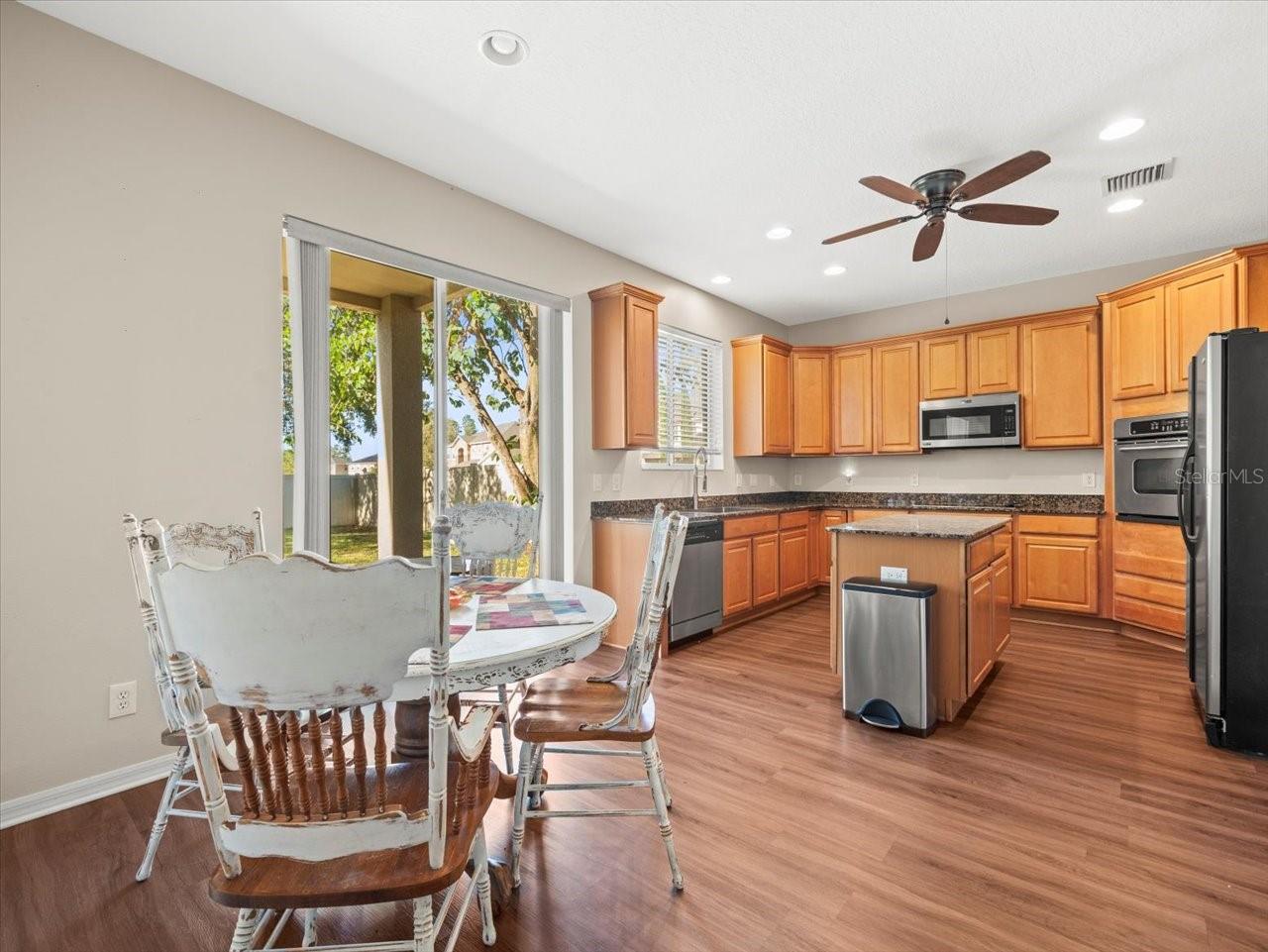 Eat in kitchen with island and slider to patio and backyard