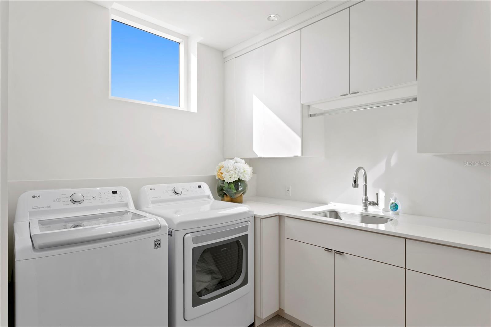 Laundry room with LG washer and dryer, built-in drying rack and ironing board