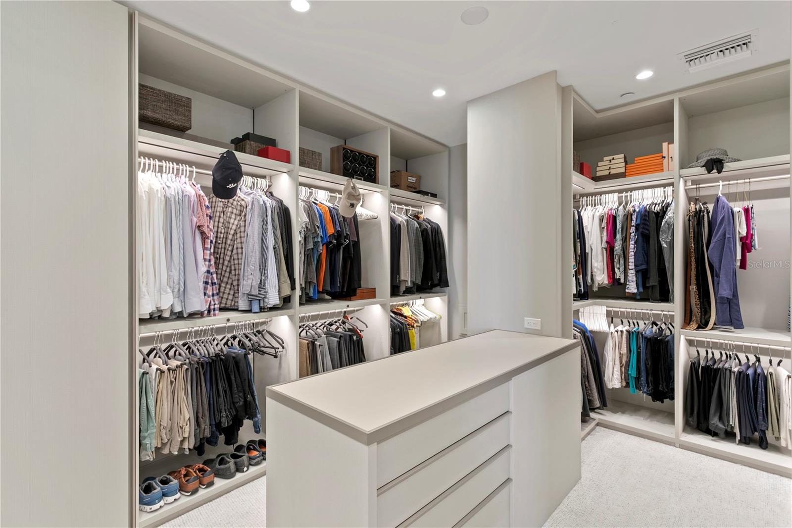 Primary Suite Walk-in closet with clothing pass-through door into the Laundry Room