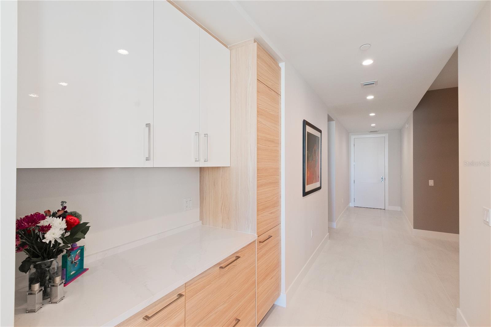 Hallway entry to den/study/third full bath and laundry room