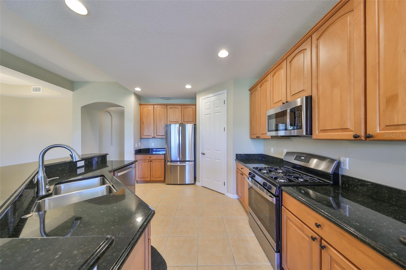 BRAND NEW STAINLESS STEEL APPLIANCES - NOTICE THE NATURAL GAS STOVE!  Tons of 42" all wood cabinets create storage for all your cooking and baking needs, while offering room for several cooks at the same time!