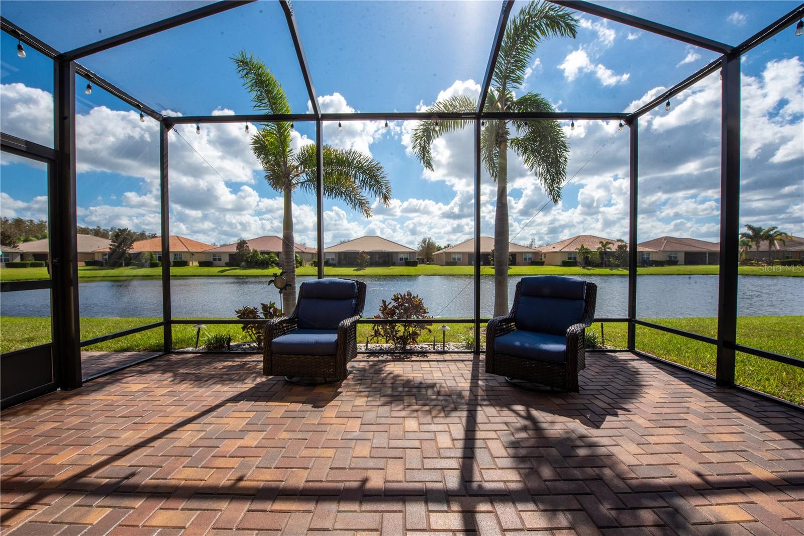 Covered rear patio with screen enclosure and pond views