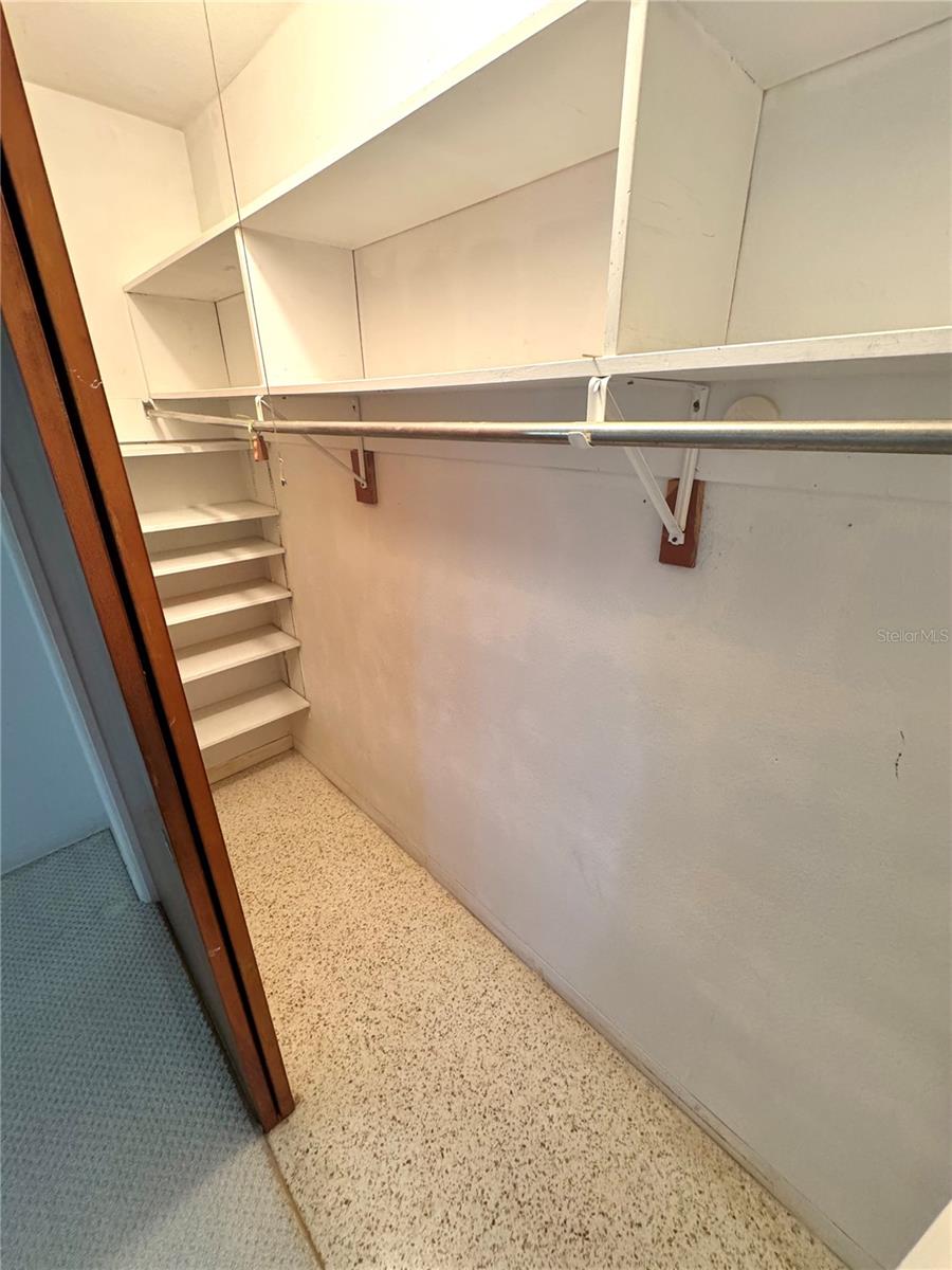 Guest bedroom closet.  This shows the terrazzo floor that is throughout the house under the existing flooring.