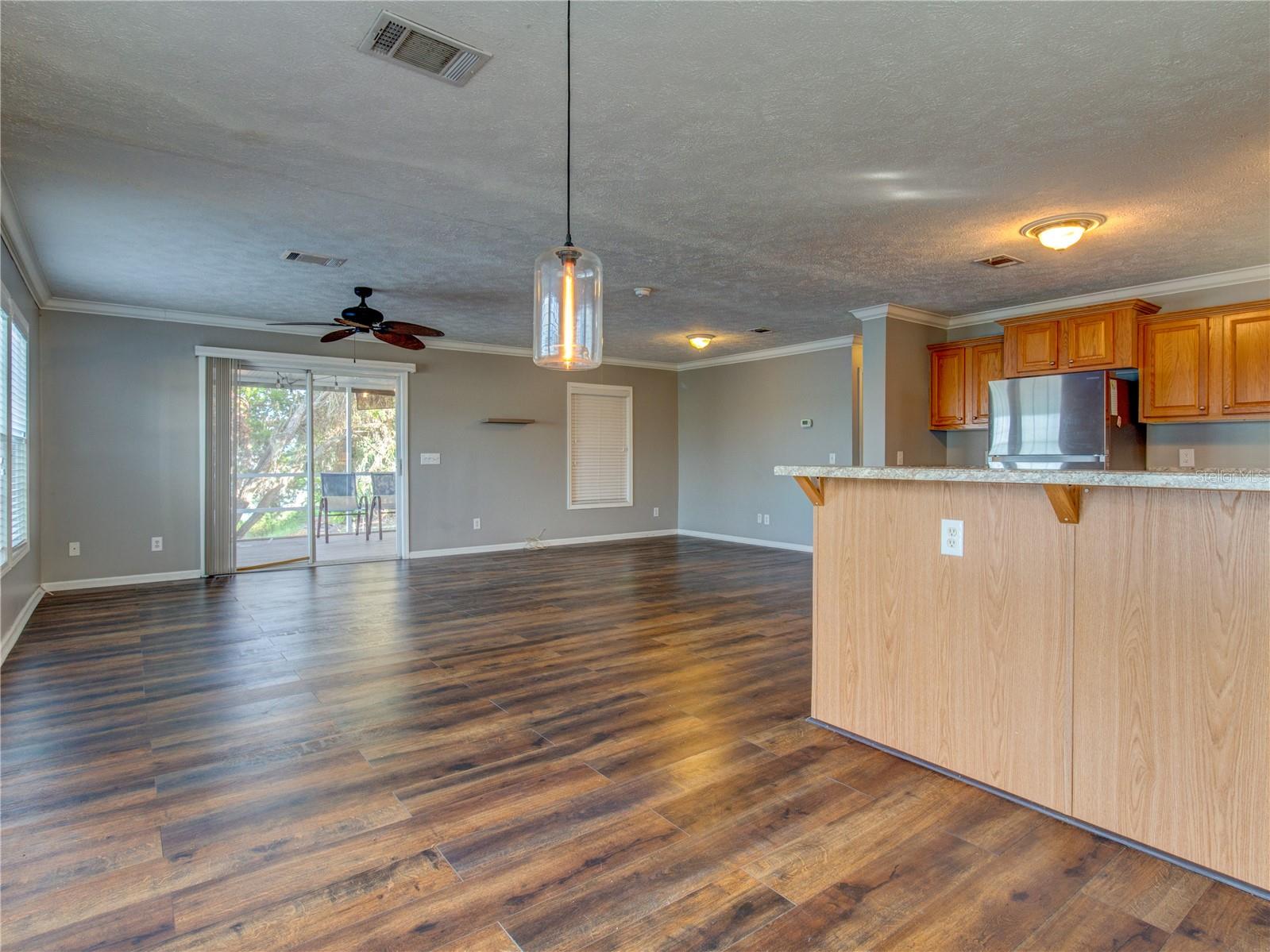 Dining Room view toward Living room and Back Enclosed/Covered/Screened Lanai at Lakefront