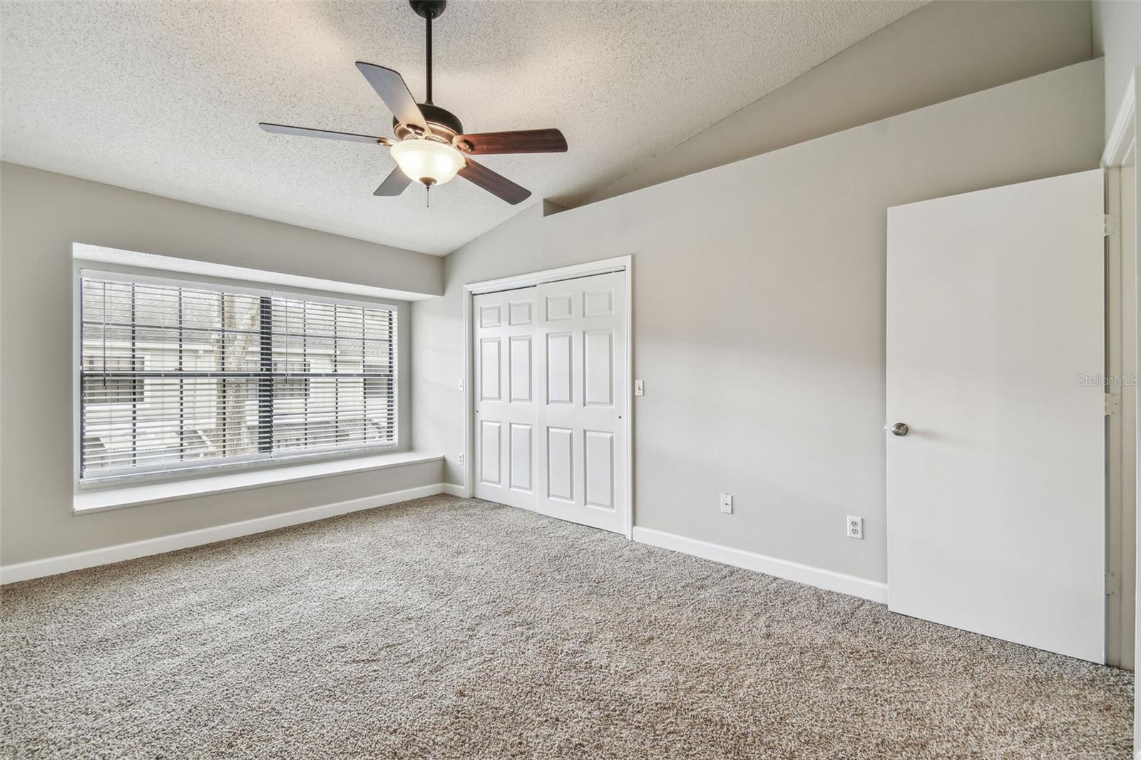 Primary bedroom window seat and custom closet.