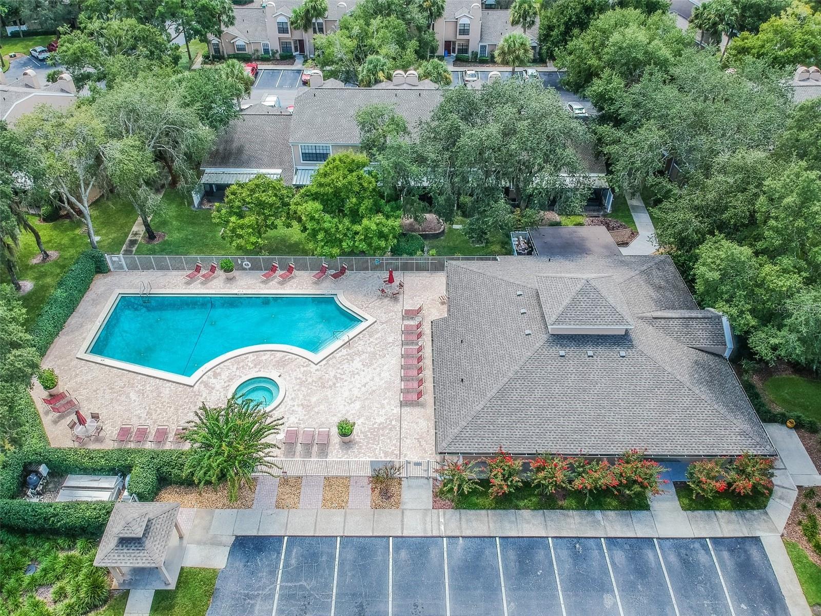 Faircrest community clubhouse, pool and spa. There are lots of lounge chairs for you to sit and relax and enjoy the Florida sunshine.